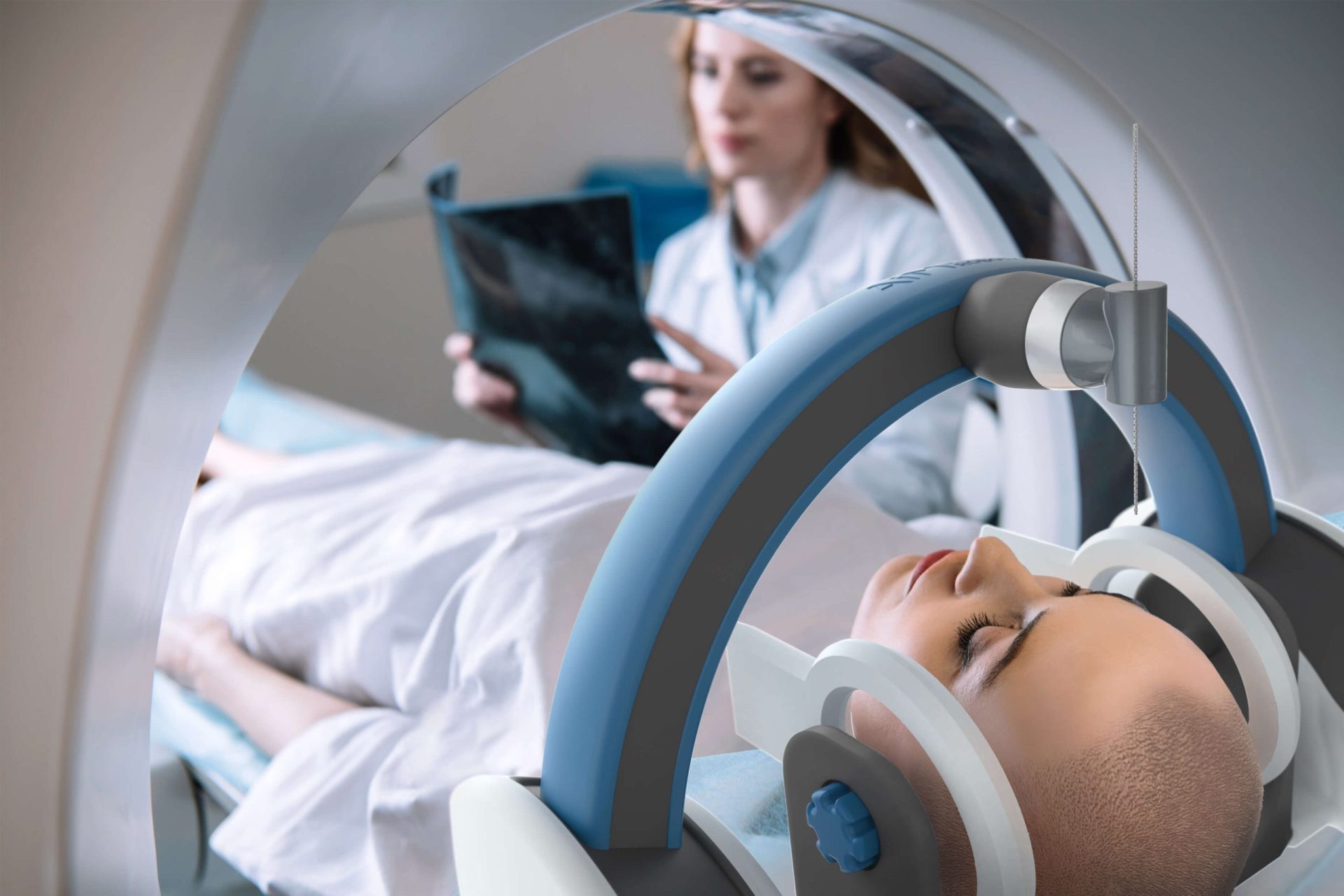 A patient in Aim Medical Robotics' MRI-compatible surgical robot, nested inside a white MRI machine with physician in the background.