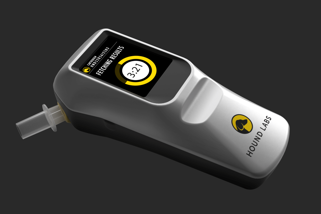 Hound Labs handheld cannabis breathalyzer device displaying progress on its screen.