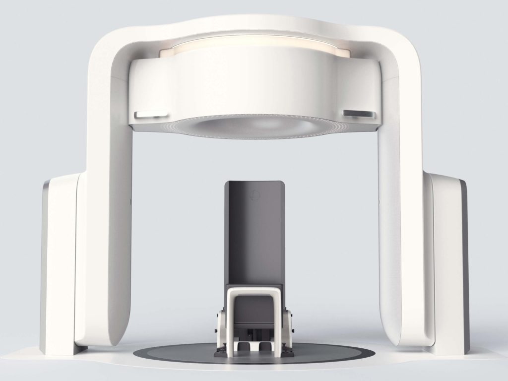 A front view of the Leo Cancer Care upright radiation therapy system, a large white device with a black chair.