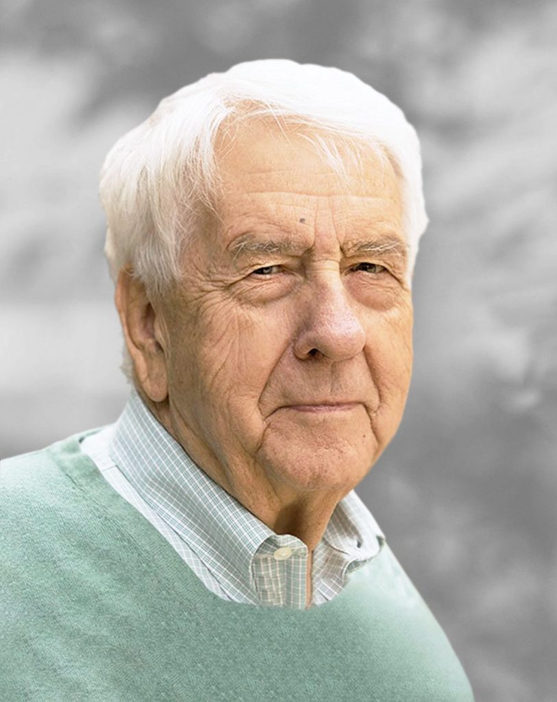 A portrait of Jack Lloyd, a man with white hair and a determined expression against a gray background.