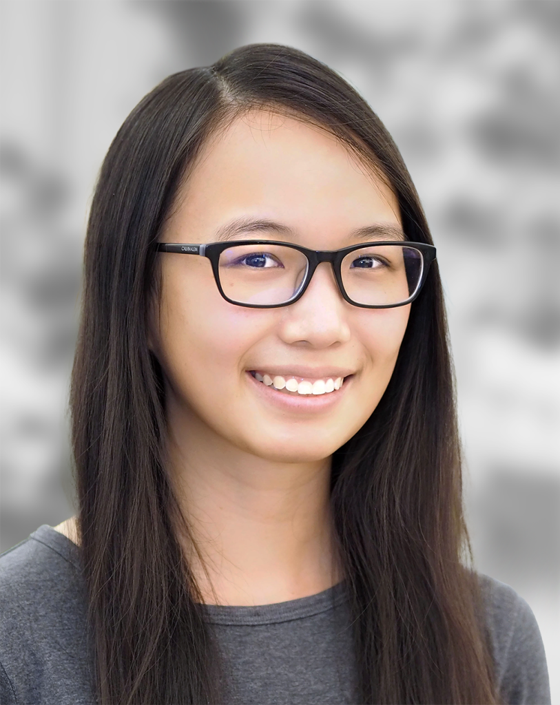 A portrait of Jenna Wen, a woman with glasses smiling at the camera.