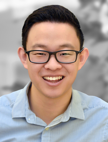 A portrait of Kevin Limtao, a smiling man with glasses wearing a blue-striped shirt.