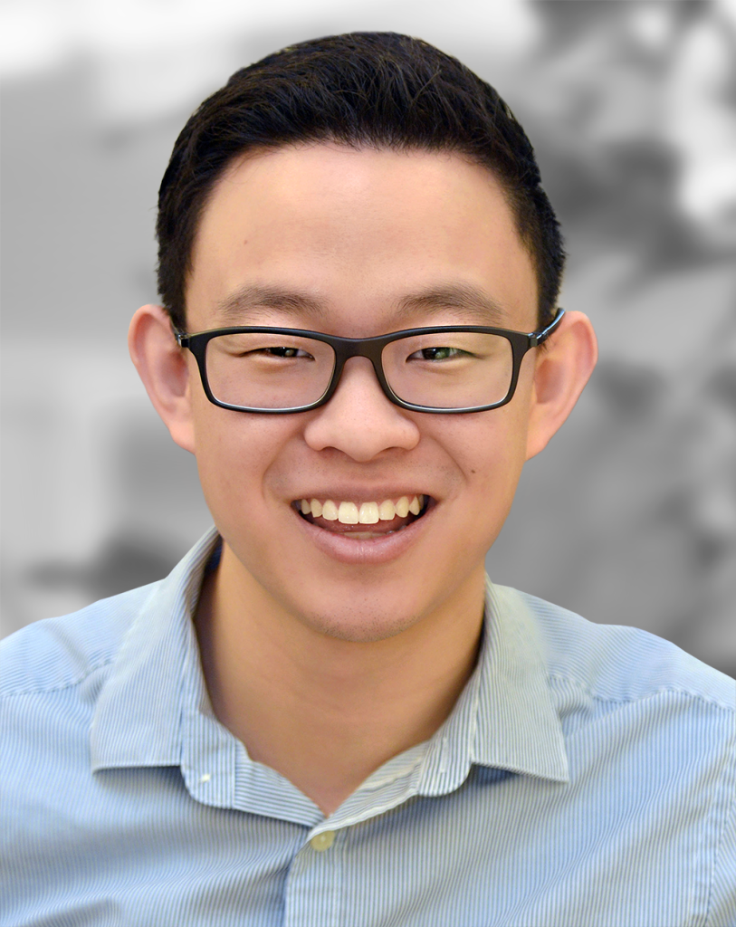 A portrait of Kevin Limtao, a smiling man with glasses wearing a blue-striped shirt.