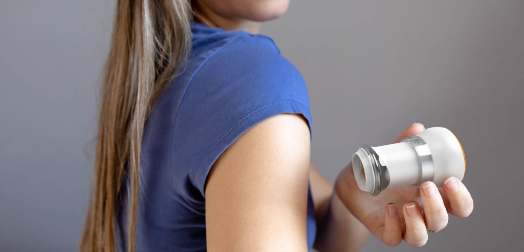 A person holding a transdermal patch applicator