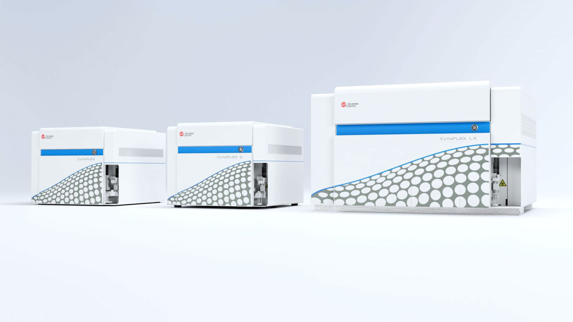 Three white and blue laboratory analyzers of varying sizes are arranged in a row on a plain background. The devices have a modern design with a hexagonal dot pattern on the front panels.