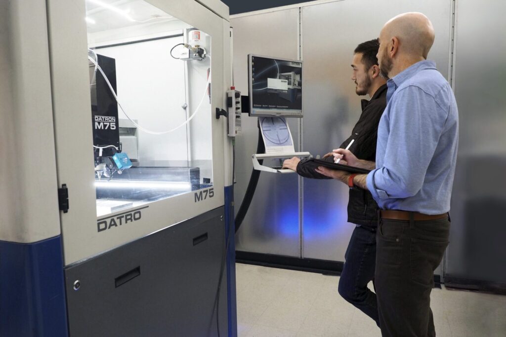 Triple Ring scientists operating a micro-mill to prototype medical devices