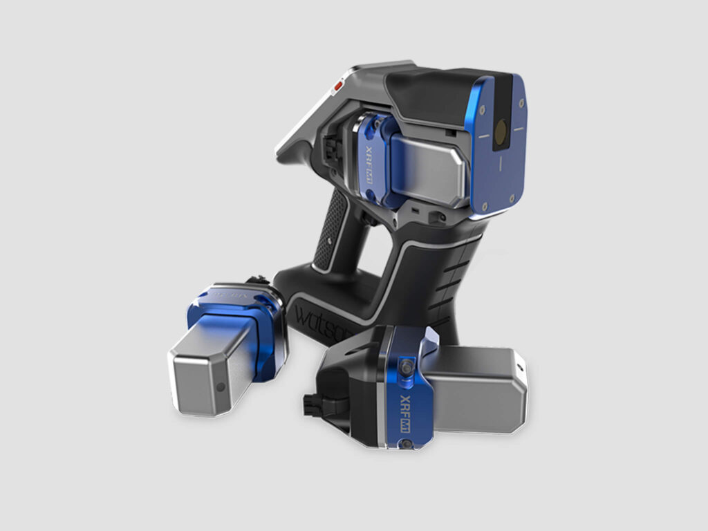 Handheld XRF analyzer with two detachable components, all in black and blue, displayed on a light gray background.